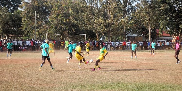 Budiope players in yellow battle Bunha in green during their MTN Busoga Masaza Cup clash at Baligeya Memorial Seed School Playground in Kamuli