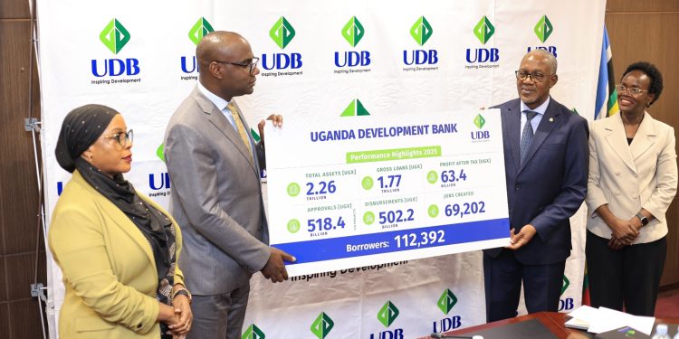 L-R_ State Minister for Investment and Privatization, Hon. Amina Mukalazi_ Finance Minister, Hon. Henry Musasizi with UDB Board Chairman, Godfrey Kihuguru and UDB MD Dr. Patricia Ojangole during the AGM