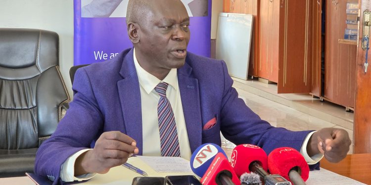 Walimu Cooperative Union Board Chairperson Steven Oringa speaks to journalists in Kampala.