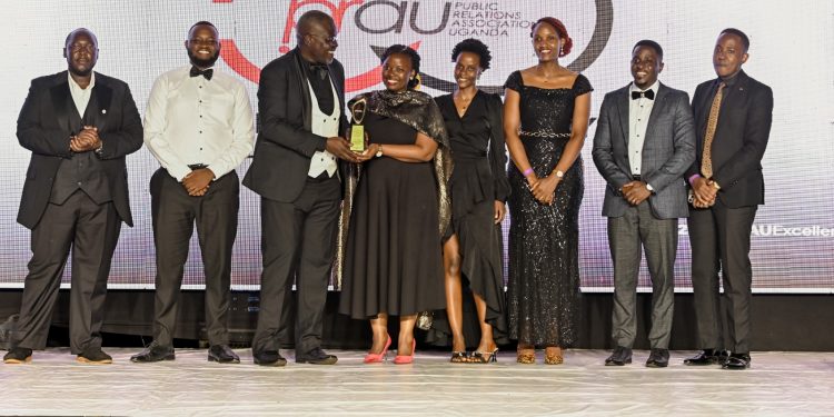 The Pearl Bank team receiving the Impact Beyond Profit Award from Patrick Ezaga (3rd Left) Director, Communications, Deposit Protection Fund. This was in recognition of the Bank's collaboration with the Joint Clinic Research Centre (JCRC) to fundraise for the first-ever Bone Marrow Transplant in Uganda, located in Lubowa, to treat blood ailments like sickle cells. This was during the 10th PRAU Excellence Awards, which marked the climax of the PRAU at 50 Anniversary Summit at the Source of the Nile Hotel in Jinja on 23rd October 2026.