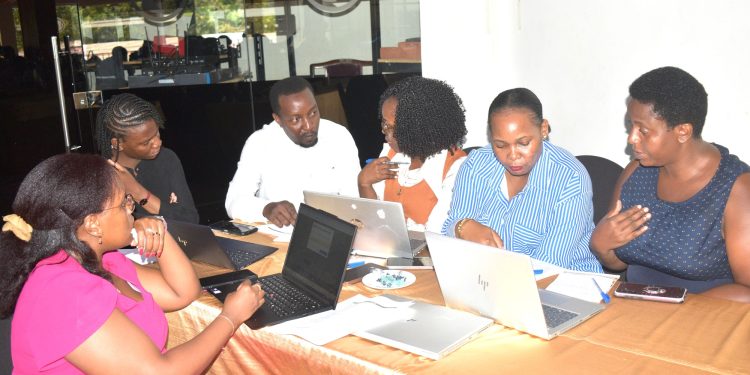Joshua Mpairwe, the lead consultant at Centric Solutions, the company that developed LAMIS, interacts with the trainees