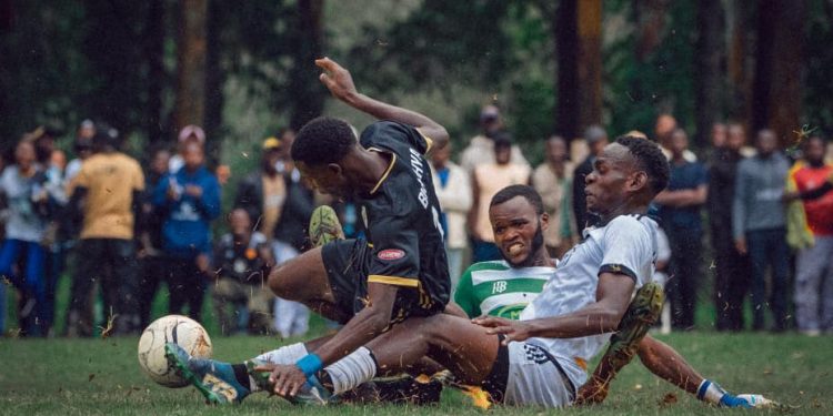 Players from Burahya County and Fort Portal City contest the ball near the goal as the goalkeeper moves to intervene during Sunday's MTN Amasaza Cup semi-final